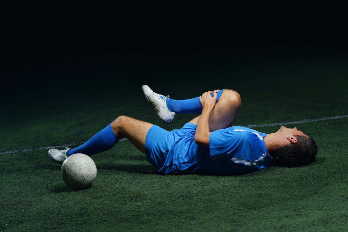 soccer player on the ground with an injury